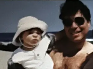 A man and child in white hats.