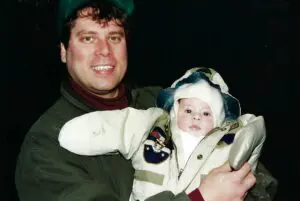 A man holding a baby in his arms.