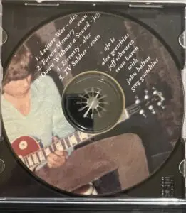 A cd with an image of a person playing guitar.