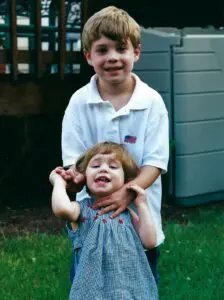 A boy and girl standing next to each other.